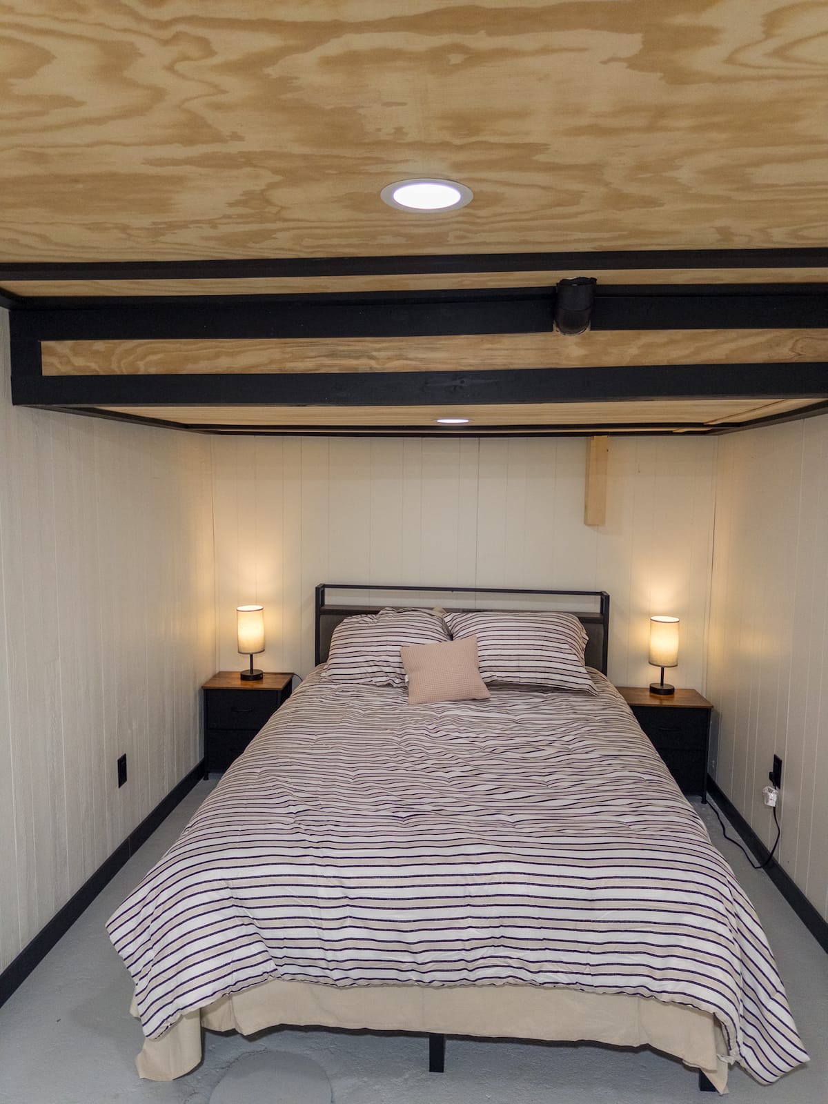 Queen bed in the Pine & Stone Stays basement suite