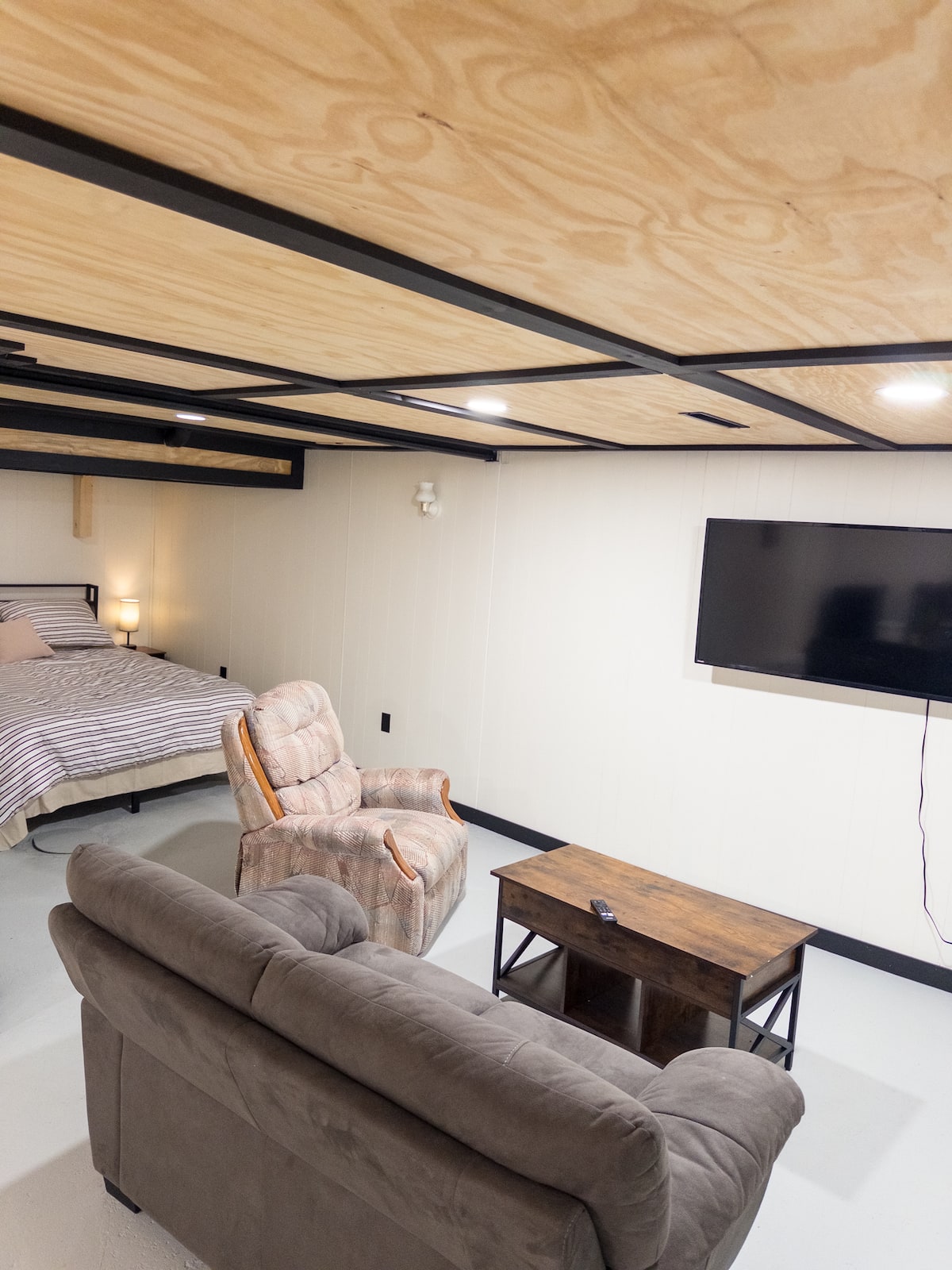 Living area with couch, armchair and smart TV